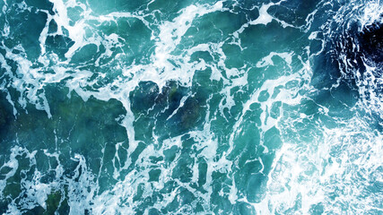 Aerial view of the ocean water surface and waves. Beautiful water background texture for tourism and advertising. Tropical coast