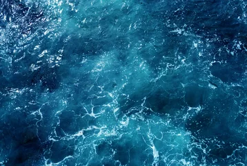 Aerial view of the ocean water surface and waves. Beautiful water background texture for tourism and advertising. Tropical coast © Payllik