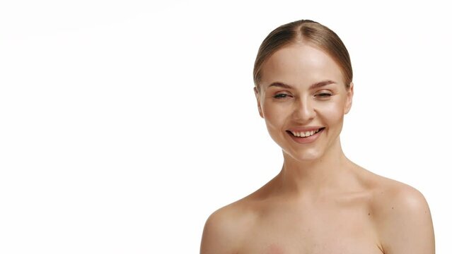 attractive young caucasian millennial girl smiles at camera showing hand OK sign. Blonde woman shows everything fine success gesture body language, demonstrates symbol of support approval