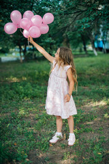 little child playing with a balloon