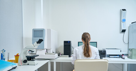 Woman works at a computer in a diagnostic laboratory