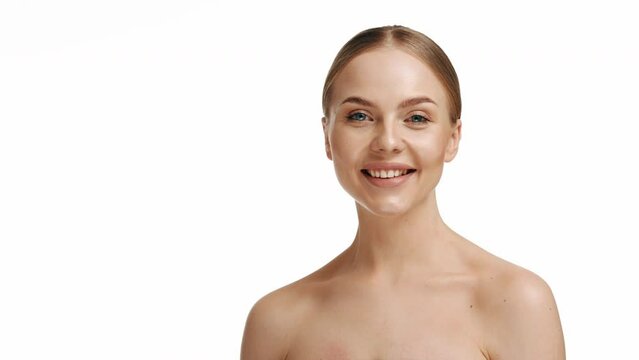 attractive young caucasian millennial girl smiles at camera showing hand OK sign. Blonde woman shows everything fine success gesture body language, demonstrates symbol of support approval