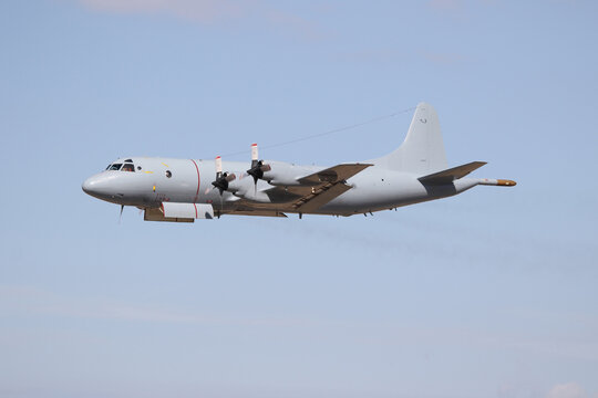 Big military transportation aircraft in the air. Lockheed P-3.