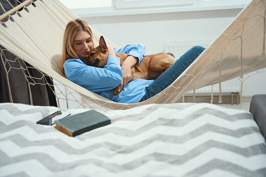 Woman hugging her favorite pet during afternoon rest