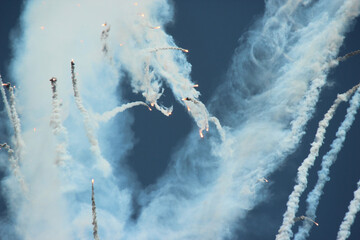 Military aircraft shooting out flares.