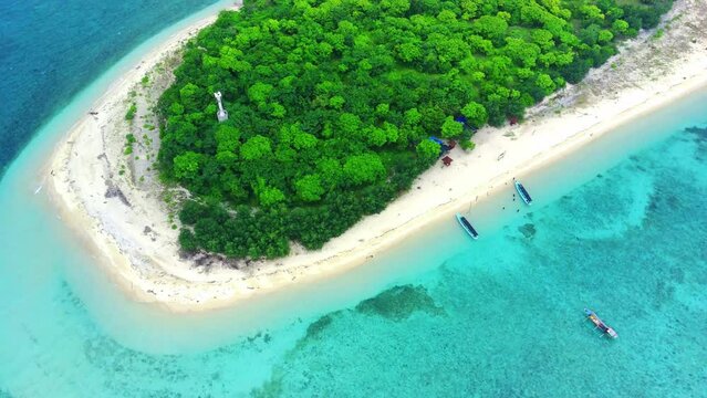 The small island named Tabuhan in the beautiful clear waters of the Bali Straits. Banyuwangi. Indonesia. Aerial footage taken with Drone.