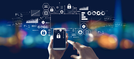 Cyber security theme with person using a smartphone in a city at night