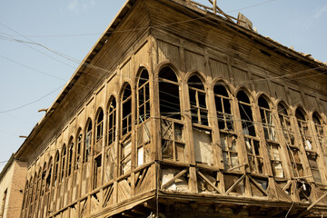 Basrah, iraq - February 15, 2023: photo of balconies and windows of  historic houses in basra city - obrazy, fototapety, plakaty