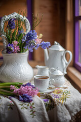 still life with geocinches, tea drinking near the window with a bouquet of spring flowers. beautiful floral background, art design, colorful bouquets.