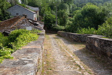 Medieval bridge over Lor river in A Ponte village (Barxa de Lor), Quiroga / A Pobra do Brollón, province of Lugo, Galicia, Spain - June 2022