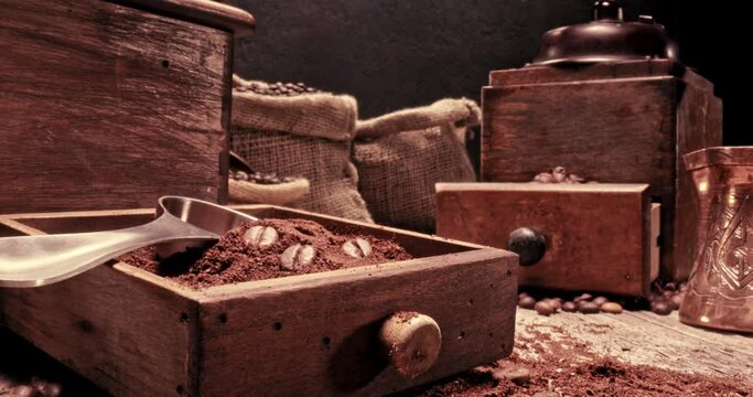 Closeup of coffee beans in vintage grinder and old sack.