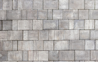 Gray paving stones texture. Paving surface road. Texture made of big gray cement bricks background