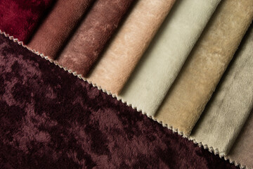 Bright collection of gunny textile samples. Multicolor fabric texture background. Samples of fabrics of different quality and category for furniture upholstery or curtains.