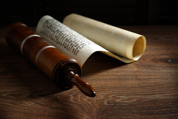 The Scroll of Esther on a dark wooden table. Rustic.