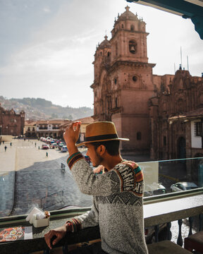 man overlooking cusco cathedral in peru