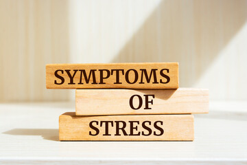 Wooden blocks with words 'Symptoms of stress'.