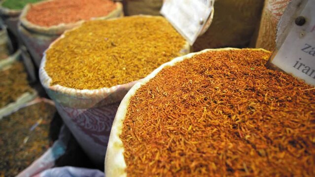 Spices in traditional egyptian market, bazaar. Colorfull and oriental shop with herbs and description signs for a type of spices on diferent languages
