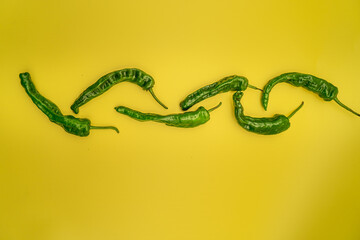 green peppers on a bright yellow background