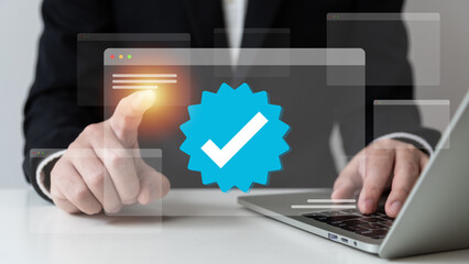 Businessman using laptop with verification account blue tick checkmark concept, verification...
