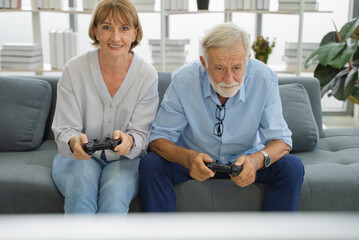 Elderly couple relax, Happy Two senior playing game together at home.