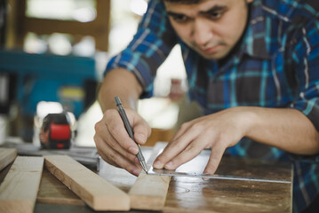 Hands of person doing diy project at home. Man measuring wood to doing cabinet craftworks as a hobby.