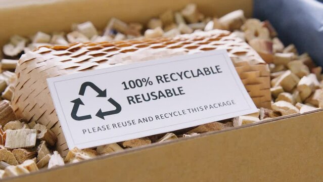 Net zero waste go green SME use eco friendly care sign plastic free symbol packaging carton box wrap paper in small shop retail store. Chva dried water hyacinth on desk reuse packing parcel supplies.