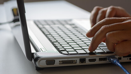 Man using laptop computer on desk for marketing business.