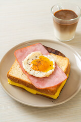 bread toasted cheese topped ham and fried egg with pork sausage