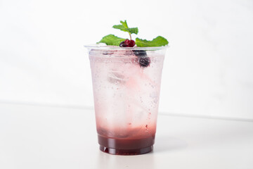 mix berry with soda in glass