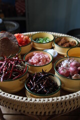 Various Thai and Chinese herbs in ceramic bowl on a dark background. Herbal and Spices Oriental marketplace.