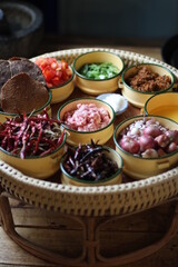 Various Thai and Chinese herbs in ceramic bowl on a dark background. Herbal and Spices Oriental marketplace.