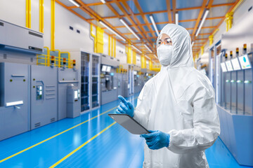Worker or engineer wears protective suit or coverall suit work in semiconductor manufacturing...