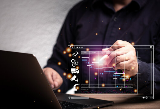The concept of scheduling management. Man using pen to make a virtual schedule planning maintenance progress through laptop, industry, machine, equipment.