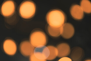 Yellow bokeh circles on a faded black background