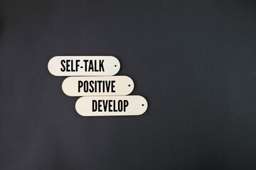 wooden board with the words Develop positive self-talk. Business and Develop positive self-talk concept.