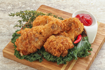 Fried chicken drumsticks with tomato sauce