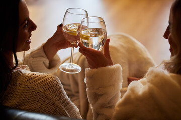 Women, wine glass and cheers to celebrate together while happy in home to relax, smile and cheers....