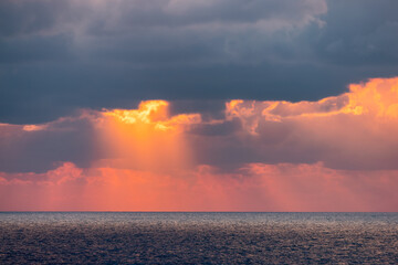 Dramatic Colorful Sunset Sky over Mediterranean Sea. Clouds with Sunrays. Cloudscape Nature Background.