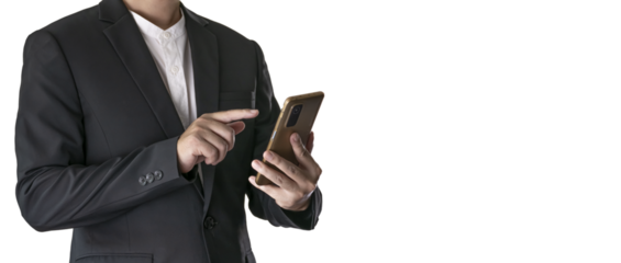 The Asian man in a black suit is standing alone and holding a phone.