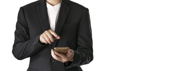 The Asian man in a black suit is standing alone and holding a phone.