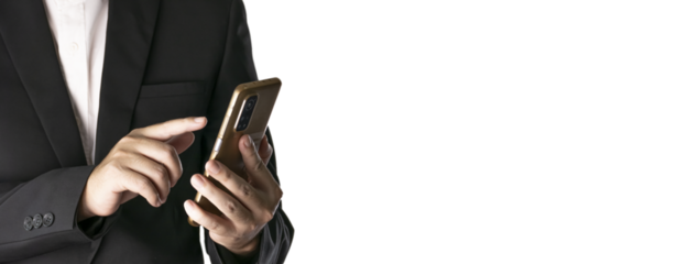 The Asian man in a black suit is standing alone and holding a phone.