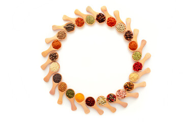 Spices pattern on a white background. A set of spices from India. Decoration design. Various spices, peppers and herbs close-up top view. A set of peppers and spices for cooking.