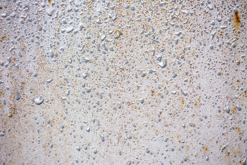 Texture of paint stains on the wall, cracked paint on an old metal surface. Sheet of silver metal with cracked and peeling paint, background for design with copy space.