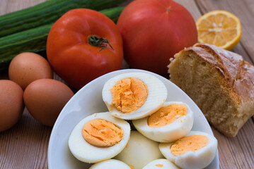chicken eggs boiled very fresh, with a round yellow or orange yolk and a well-formed white. eggs on a wooden table