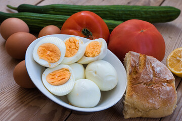 chicken eggs boiled very fresh, with a round yellow or orange yolk and a well-formed white. eggs on a wooden table