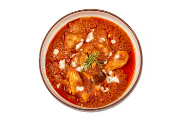 Top view of Panang pork curry with coconut milk and sliced kaffir lime leaves in a bowl isolated on white background, Panang curry is a very popular Thai dish.