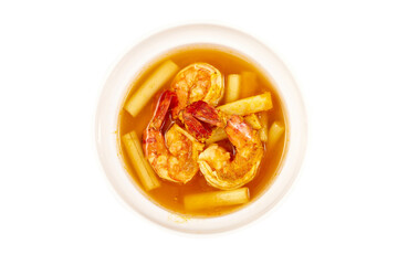 Top view of Sour soup with lotus stem and shrimps in a white bowl isolated on white background. local food of Thailand.