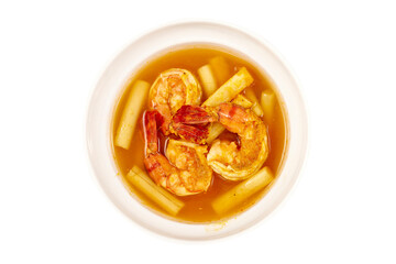 Top view of Sour soup with lotus stem and shrimps in a white bowl isolated on white background. local food of Thailand.