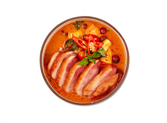 Top view of Red curry with roasted duck isolated on white background, this food contains such as red curry paste, chili, tomato and pineapple.