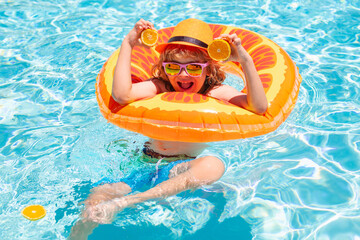 Fun child portrait. Kid boy in sunglasses in pool in summer day. Children playing in swimming pool. Summer holidays and vacation concept.
